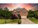 Charming two-story brick home with lush landscaping and a spacious driveway leading to a two-car garage at 638 Glen Valley Way, Dacula, GA 30019