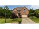 Traditional brick home with well-maintained lawn, mature trees, and attached two-car garage at 638 Glen Valley Way, Dacula, GA 30019