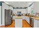 Bright kitchen featuring white cabinets, granite countertops, stainless steel appliances, and hardwood floors at 638 Glen Valley Way, Dacula, GA 30019