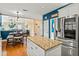 Open concept kitchen featuring white island, stainless steel appliances, and hardwood floors at 638 Glen Valley Way, Dacula, GA 30019