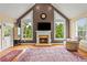 Cozy living room features a fireplace, high ceilings, hardwood floors and natural light at 638 Glen Valley Way, Dacula, GA 30019