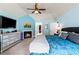 Bright main bedroom featuring a fireplace, ceiling fan, and en-suite bath at 638 Glen Valley Way, Dacula, GA 30019