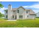 The home's backyard featuring a patio, chimney, lawn and the white siding of the home at 6799 Hill Creek Cv, Lithonia, GA 30058