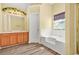 Bright bathroom features a soaking tub, double vanity, and neutral color palette at 6799 Hill Creek Cv, Lithonia, GA 30058