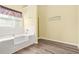 Bathroom featuring a soaking tub, walk-in shower, and wood-look flooring at 6799 Hill Creek Cv, Lithonia, GA 30058