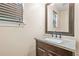 Elegant bathroom with a granite countertop vanity, framed mirror, and modern fixtures, offering a touch of luxury at 6799 Hill Creek Cv, Lithonia, GA 30058