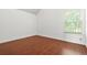 Bright bedroom showcases hardwood flooring and a large window for ample natural light at 6799 Hill Creek Cv, Lithonia, GA 30058