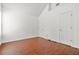 A spacious bedroom is freshly painted with hardwood flooring, two doors, and a vaulted ceiling at 6799 Hill Creek Cv, Lithonia, GA 30058