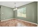 Inviting dining room with beautiful tile flooring and a modern light fixture, perfect for Gathering meals at 6799 Hill Creek Cv, Lithonia, GA 30058