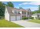 Brick home on a large lot with a two car garage and traditional shutters on the windows at 6799 Hill Creek Cv, Lithonia, GA 30058