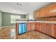 Efficient kitchen featuring wood cabinets, modern fixtures, and stainless steel dishwasher, offering functionality and style at 6799 Hill Creek Cv, Lithonia, GA 30058