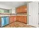Well-equipped kitchen with wooden cabinets, and a stainless steel dishwasher, perfect for easy meal preparation at 6799 Hill Creek Cv, Lithonia, GA 30058