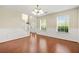 Bright living room featuring hardwood floors, a staircase, and plenty of natural light from multiple windows at 6799 Hill Creek Cv, Lithonia, GA 30058