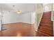 Spacious living room with hardwood floors, stairs, and an open floor plan at 6799 Hill Creek Cv, Lithonia, GA 30058