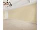 Generously sized main bedroom featuring neutral carpeting, a stylish ceiling fan, and ample natural light at 6799 Hill Creek Cv, Lithonia, GA 30058