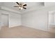 Bright bedroom with neutral carpet and ceiling fan, offering ample space and comfort at 1400 Gray Branch Dr, Lawrenceville, GA 30045