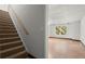 A staircase leads down to a finished basement with natural light and a neutral color scheme at 194 Lake Ruby Dr, Suwanee, GA 30024