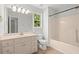 A well-lit bathroom features a vanity with drawers, a large mirror, and a shower-tub combination at 194 Lake Ruby Dr, Suwanee, GA 30024