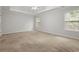 Spacious bedroom with neutral walls, a ceiling fan, and natural light from two windows at 194 Lake Ruby Dr, Suwanee, GA 30024