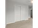 A bedroom features a closet and ceiling fan for storage and comfort at 194 Lake Ruby Dr, Suwanee, GA 30024