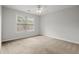 A bright bedroom with a large window and neutral walls and flooring provides a serene atmosphere at 194 Lake Ruby Dr, Suwanee, GA 30024