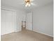 A bedroom with a ceiling fan and a closet with white doors provides ample storage space at 194 Lake Ruby Dr, Suwanee, GA 30024