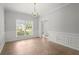Spacious dining room with classic chandelier and trim at 194 Lake Ruby Dr, Suwanee, GA 30024