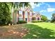 Two-story home with a lush green lawn, and well maintained landscaping at 194 Lake Ruby Dr, Suwanee, GA 30024