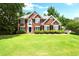 Gorgeous two-story brick home with well-manicured lawn and landscaping at 194 Lake Ruby Dr, Suwanee, GA 30024