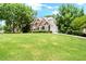 Two-story home featuring a lush green lawn and a two car garage at 194 Lake Ruby Dr, Suwanee, GA 30024