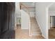 Inviting entryway with staircase, neutral tile flooring, and a view into the living room at 194 Lake Ruby Dr, Suwanee, GA 30024