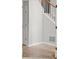 Hallway features stairs with white spindles and stained wood handrail at 194 Lake Ruby Dr, Suwanee, GA 30024