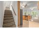 Carpeted stairs leading to kitchen area with stainless steel appliances, granite countertops, and breakfast nook at 194 Lake Ruby Dr, Suwanee, GA 30024