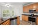 Bright kitchen with wood cabinets, stainless steel appliances and granite countertops at 194 Lake Ruby Dr, Suwanee, GA 30024