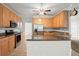 Bright kitchen with wood cabinets, granite countertops, stainless steel appliances and a ceiling fan at 194 Lake Ruby Dr, Suwanee, GA 30024