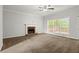Bright living room with brick fireplace and large windows at 194 Lake Ruby Dr, Suwanee, GA 30024