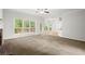 Living room with fireplace, large windows and carpeted flooring at 194 Lake Ruby Dr, Suwanee, GA 30024