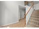 Neutral colored carpeted staircase with white risers and natural wood railing at 194 Lake Ruby Dr, Suwanee, GA 30024