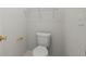 Small toilet room with a standard toilet and wall-mounted shelving at 194 Lake Ruby Dr, Suwanee, GA 30024