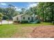 Spacious backyard with a green deck and a large lawn, perfect for outdoor activities and relaxation at 402 Princeton Way, Lawrenceville, GA 30044