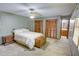 Spacious bedroom with striped wallpaper, wood closets, and a neutral carpet at 402 Princeton Way, Lawrenceville, GA 30044