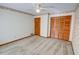 Empty bedroom with patterned wallpaper, wood closet, and neutral carpet at 402 Princeton Way, Lawrenceville, GA 30044