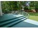 Green painted deck with stairs and railing, offers a peaceful spot to enjoy the outdoors at 402 Princeton Way, Lawrenceville, GA 30044