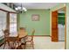 Green dining room area with a dining table and bay window with white blinds at 402 Princeton Way, Lawrenceville, GA 30044