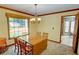 Cozy dining room featuring a wood table, chandelier, and a view of the backyard at 402 Princeton Way, Lawrenceville, GA 30044
