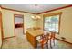 Cozy dining room featuring a wood table, chandelier, and a view of the backyard at 402 Princeton Way, Lawrenceville, GA 30044