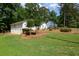 Property view showing an additional unit with landscaping and lawns on a sunny day at 402 Princeton Way, Lawrenceville, GA 30044