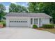 This single-story home features an attached garage, bay window, and nicely manicured yard at 402 Princeton Way, Lawrenceville, GA 30044