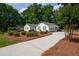 Charming single-story home with a well-manicured front yard, lush landscaping, and a concrete driveway at 402 Princeton Way, Lawrenceville, GA 30044
