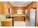 Traditional kitchen featuring wood cabinets, stainless steel appliances, and laminate countertops at 402 Princeton Way, Lawrenceville, GA 30044